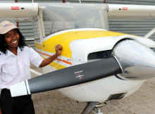 Former KAYEC after-school participant Bertha Mawano, 23, shows her pilot’s stripes at Eros Airport, 22 August 2015.