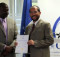 KAYEC Director Nelson Prada (right) receives accreditation from NQA council member Vitura Kavari, 11 December 2015
