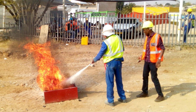 Petrus Thomas (right), founder and owner of BIC training, leads onsite training on industrial firefighting with Valleis Property and Renovation construction company in Khomasdal, September 2015.