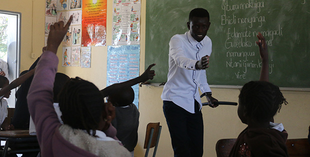 Petrus Namadiko, 21-year-old graduate of KAYEC’s Rundu youth centre, teaches the Grade 2 Rukwangali class at Rundu Junior Primary School, 5 August 2016. He will start his education degree soon - and meanwhile, the teaching strategies that he learned at KAYEC already equip him to lead the class. Every weekday afternoon at KAYEC, two full-time KAYEC youth staff and a team of 15 skilled volunteers offer academic enrichment to the next generation of learners like Namadiko, focusing on math, English and accounting, plus sports, agriculture, culture, leadership training and discussion of relationships that builds on what learners get in school. Today, other teachers have already adopted Namadiko's language-learning methods. Says Principal Kerttau Aisindi: “He’s good! He knows how to communicate with learners.”